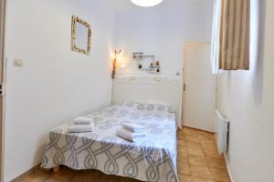 ein kleines Schlafzimmer mit einem Bett mit Handtüchern darauf in der Unterkunft Petite Maison Campomoro in Campomoro