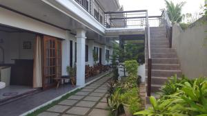 a courtyard of a house with stairs and plants at Residencia Lourdes in Mactan