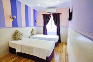 Postel nebo postele na pokoji v ubytování Q Songchi Hotel