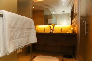 a bathroom with a sink and a towel at Erbil Rotana in Erbil