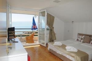 a bedroom with a bed and a view of the ocean at Villa Angelos in Ohrid +50 photos