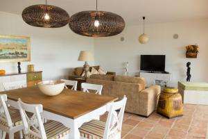 a living room with a table and a couch at Amazing Windmillhouses in Olhão