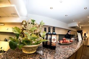 two bottles of wine on a counter in a kitchen at Hotel El Cortijo in Neuquén
