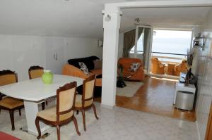 a kitchen and living room with a table and chairs at Villa Angelos in Ohrid