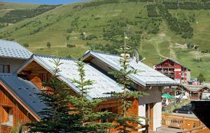 a group of buildings with solar panels on their roofs at Odalys Chalet Le Marmotton in Les Deux Alpes