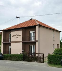 a house on the side of a street at Apartmani Matosevic in Ivankovo