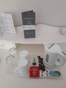 a white counter with some items on a shelf at Hotel du Soleil et Spa in Saint-Rémy-de-Provence