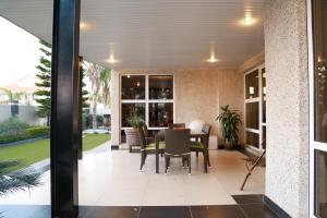 a dining room with a table and chairs at Cycad Palm Hotel in Gaborone