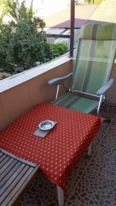 a table and a chair with a plate on it at Casa Didina in Năvodari