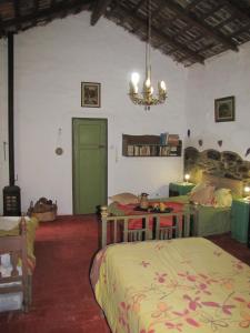 a bedroom with two beds and a chandelier at La Casona del Río in Valle Hermoso