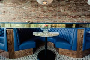 a blue bar with a table and a brick wall at Osprey Hotel in Naas +37 photos