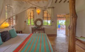 a bedroom with a large bed in a room at Matemwe Beach House in Matemwe