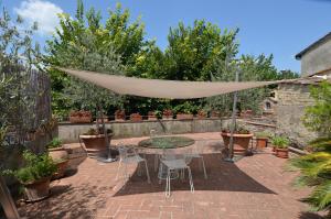 a patio with a table and chairs and a hammock at Casa Bardi in San Gimignano