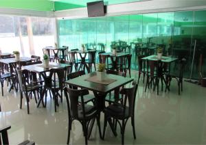 a group of tables and chairs in a restaurant at Resort Hotel Atlantic City Nautico Club in Teresina