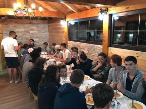 a group of people sitting at tables in a restaurant at Hostel Highlander in Žabljak