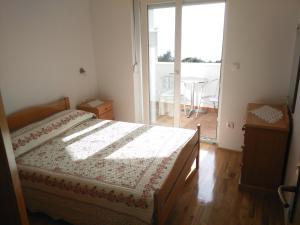 Postel nebo postele na pokoji v ubytování Vacation apartments Feniks