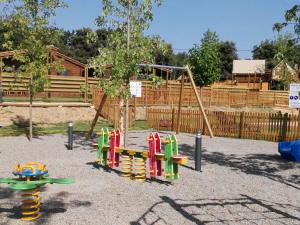 a playground with a slide and a swing at Càmping Rural Montori in Ultramort