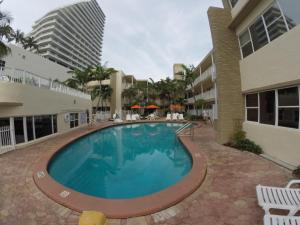 a swimming pool in front of a building at Silver Seas Beach Resort in Fort Lauderdale