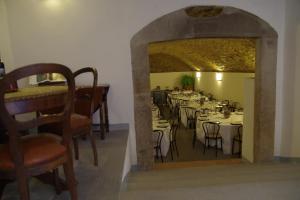a dining room with tables and chairs and a mirror at Mezzano In Chianti in Strada