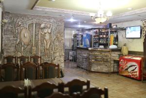 a restaurant with a wall with a mural of a woman at Astarta Inn in Kamianets-Podilskyi
