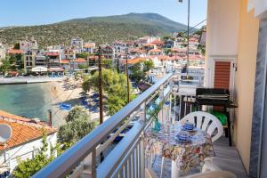 a balcony with a table and a view of a city at Casa Del Sol in Skala Marion