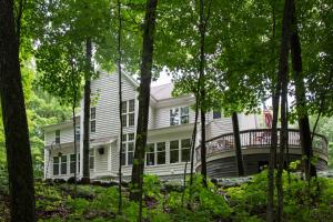 a large white house surrounded by trees at Hidden Serenity Bed and Breakfast in West Bend