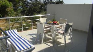 a patio table and chairs on a balcony at Magic Beach Apartments in Kyrenia