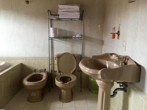 a bathroom with a sink and a toilet and a sink at Hotel Tierra Maya in San Cristóbal de Las Casas