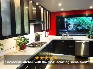 a kitchen with a stove and a tv in it at Bali Hai Castro in San Francisco