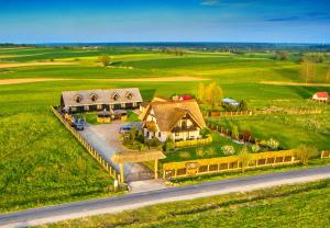 an aerial view of a house in the middle of a field at Pod Strzechą in Darłowo