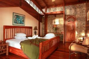 a bedroom with a large bed in a room at Aguila de Osa Rainforest Lodge in Drake