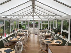an empty dining room with tables and chairs at The Mariner Hotel in Kippford