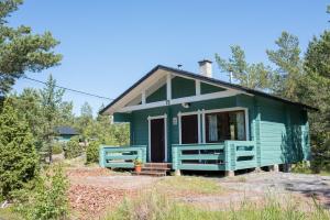 a green tiny house in the woods at Herrö stugor in Lemland +24 photos