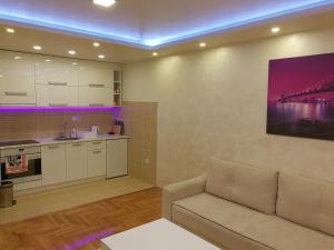 a living room with a couch and a kitchen at Istocno Sarajevo 02 in Sarajevo