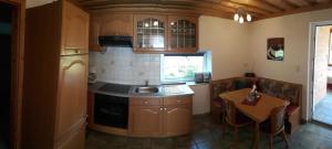 a kitchen with a sink and a table in it at Haus Elisabeth in Napplach