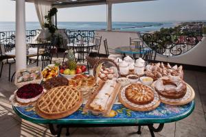 a table full of different types of bread and pastries at Sympathy Hotel in Martinsicuro