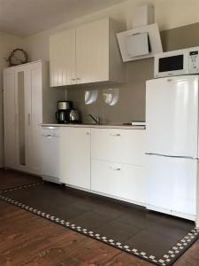 a kitchen with white cabinets and a white refrigerator at Apartament KORAB Władysławowo-Cetniewo in Władysławowo