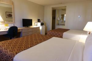 a hotel room with two beds and a desk at Armada Inn Motel in Unity