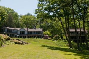 a large house on a hill with a yard at Coveside Bed & Breakfast in Georgetown