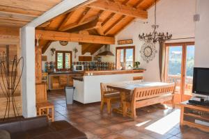 a kitchen with a table and a dining room at Chalet des Trappeurs Coeur Vanoise 15 persons in Champagny-en-Vanoise