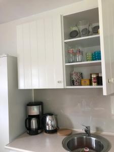 a kitchen counter with a sink and a cupboard at Apartament KORAB Władysławowo-Cetniewo in Władysławowo