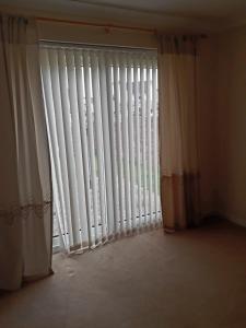 a window with white blinds in a room at Handy Dale House in Bathgate