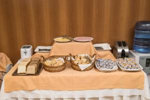 a table topped with plates of food and drinks at King David Flat Hotel - Argentina in Córdoba