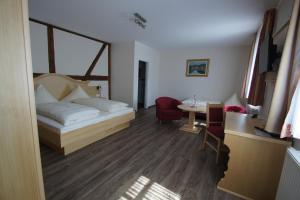 um quarto de hotel com uma cama e uma mesa em Gasthof Schönau em Heilsbronn