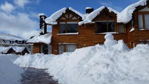 a pile of snow in front of a house at Galileo Boutique Hotel in San Carlos de Bariloche