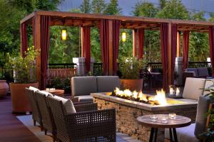 a patio with a fire pit with chairs and tables at Andaz Napa - a concept by Hyatt in Napa