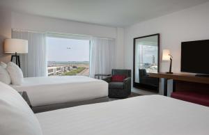 a hotel room with two beds and a large window at Hyatt Regency Boston Harbor in Boston +32 photos