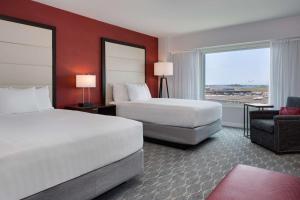 a hotel room with two beds and two lamps at Hyatt Regency Boston Harbor in Boston