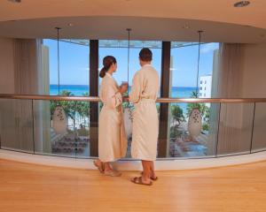 
a man and a woman standing in front of a window at Hyatt Regency Waikiki Beach Resort & Spa in Honolulu
