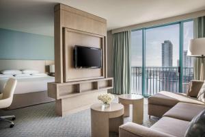 a hotel room with a bed and a tv at Hyatt Regency Jacksonville Riverfront in Jacksonville